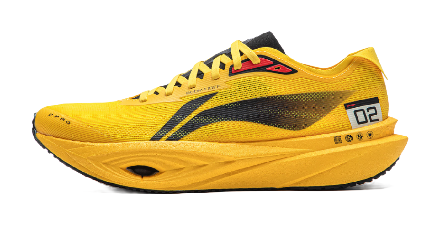 Yellow low-top running shoe with black stripe, lace-up, and contrast heel patch.