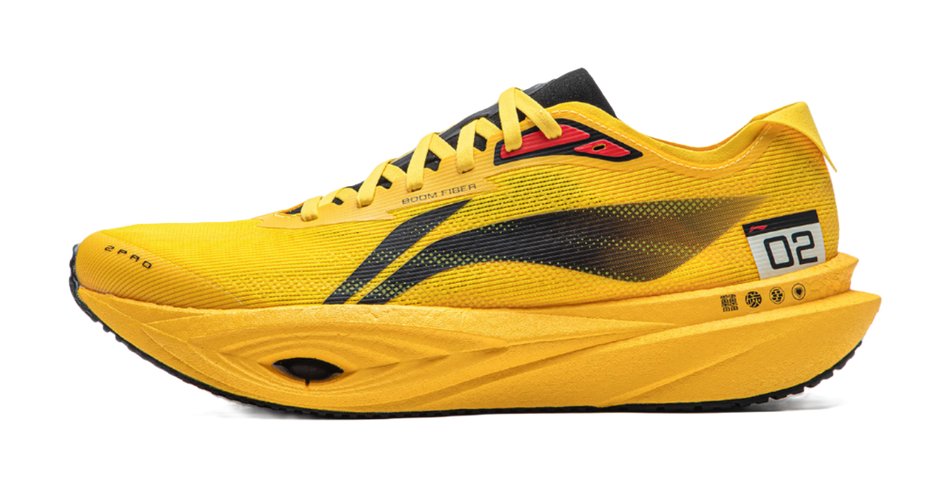 Yellow low-top running shoe with black stripe, lace-up, and contrast heel patch.