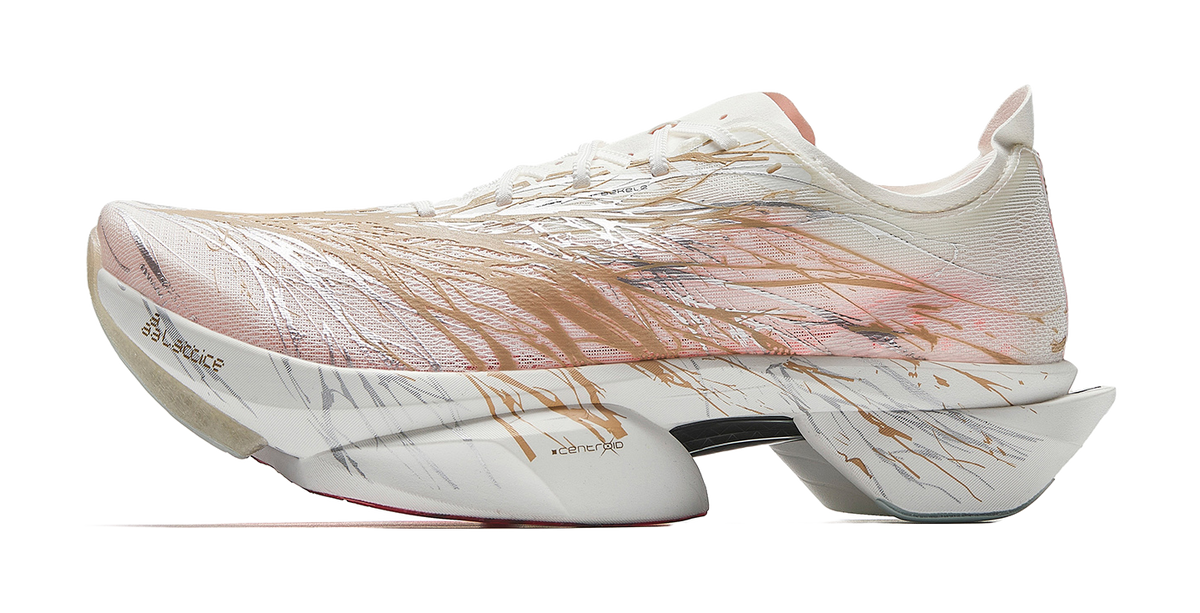 Marathon racing shoes in white with bronze-gold upper and patterned side, angled view