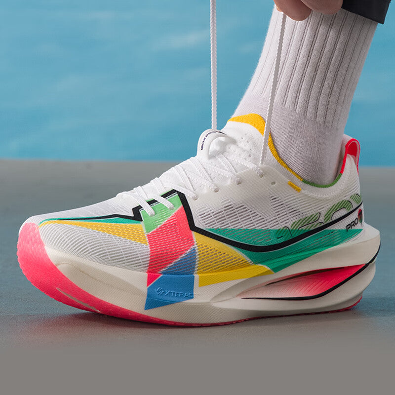 Xtep marathon racing shoe on foot, white upper with multicolor panels and red-tinted sole.