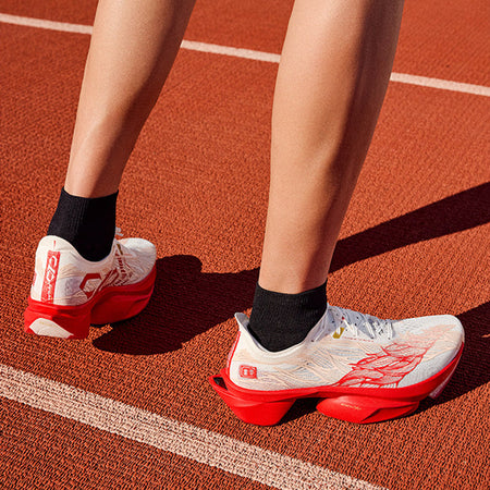 Anta C10 PRO 2.0 running shoes on feet with black crew socks, white and red design