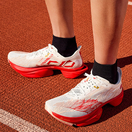 Anta C10 PRO 2.0 running shoes worn with black socks, white upper and red accents