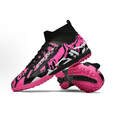 Soccer shoe with black and pink upper and turf studs on the rubber outsole