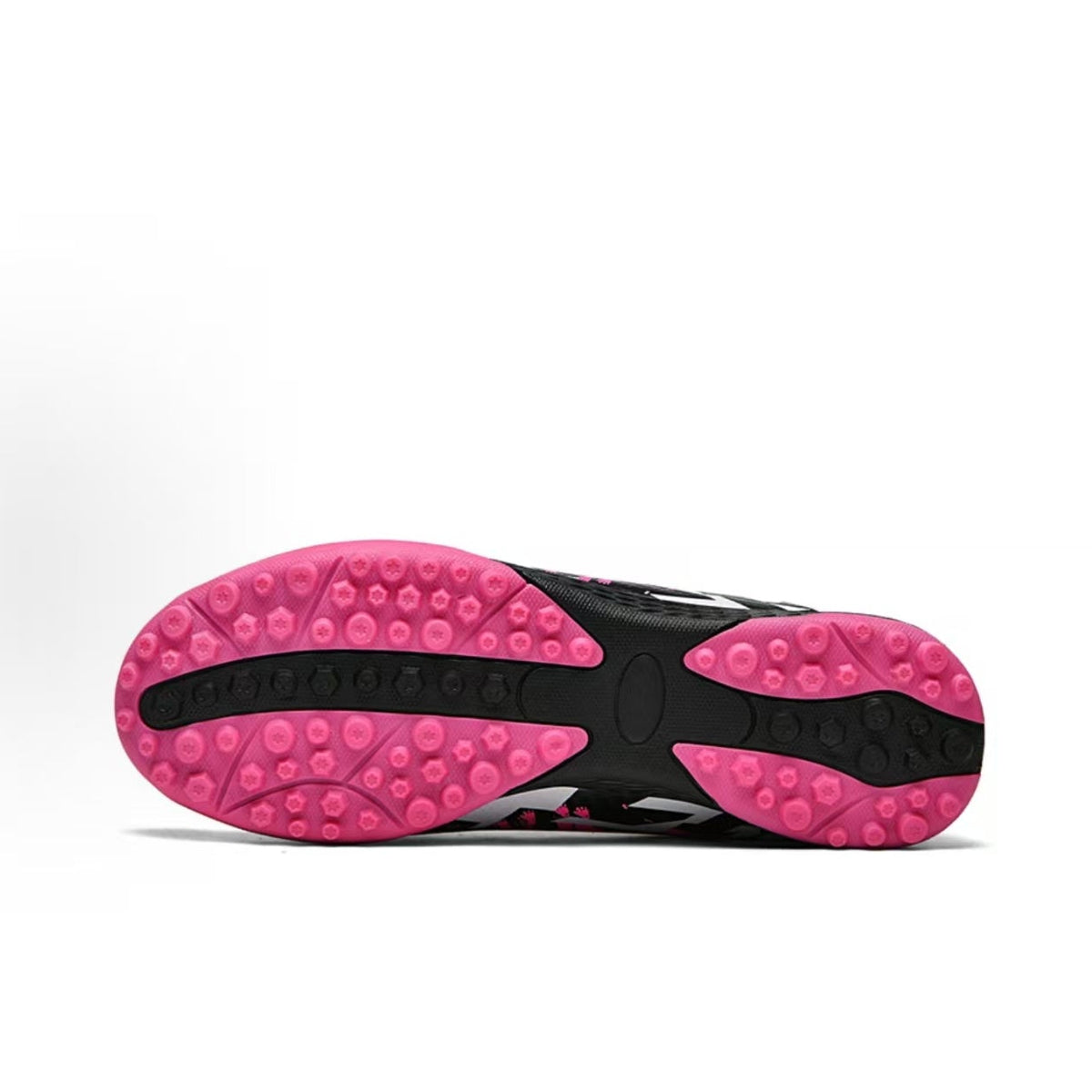 Soccer shoe outsole tread with black center and pink rubber knobs for traction