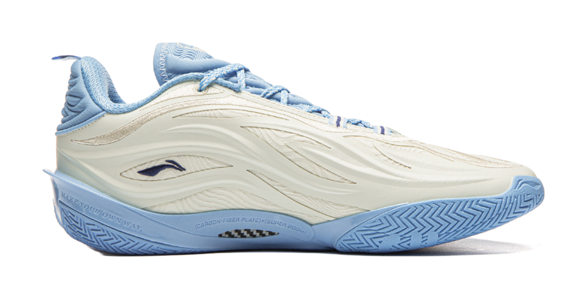 Unisex basketball shoe side view in milky white and light blue with sculpted stripes.