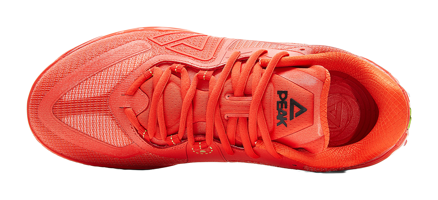 Orange-red lace-up basketball shoe, top view of tongue, laces, and patterned upper.