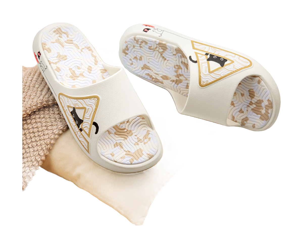 White slide sandal pair with cat logos on uppers and textured patterned footbeds