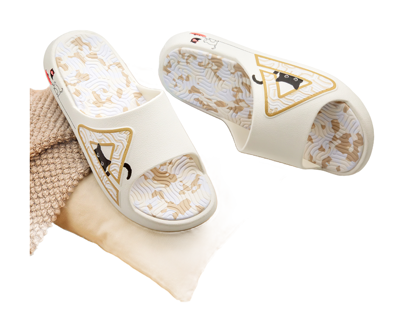 White slide sandal pair with cat logos on uppers and textured patterned footbeds