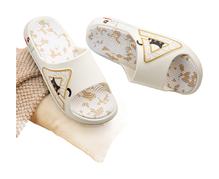 White slide sandal pair with cat logos on uppers and textured patterned footbeds