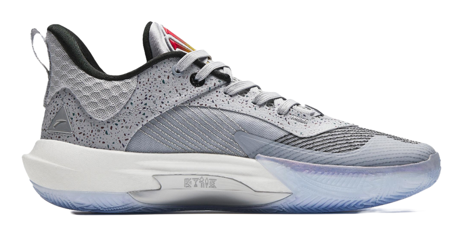 Light gray basketball shoes with black detailing, lace-up design and blue-toned outsole