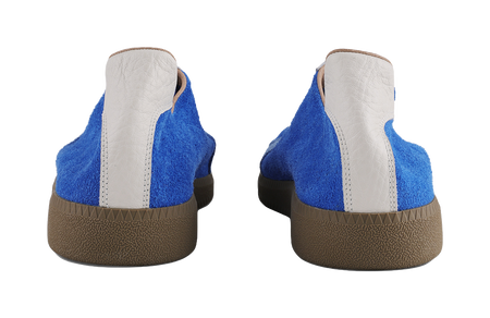 Heel view of blue low-top trainers with white back panels and brown outsole.