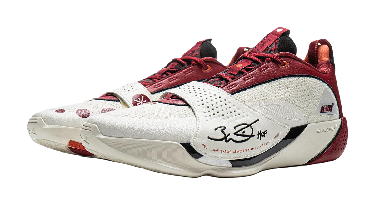 Red and white basketball shoe with laced front and white midsole with logos