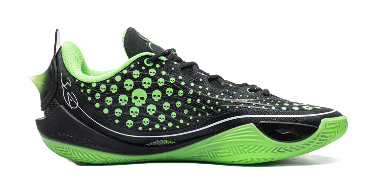Black low basketball shoe with neon green trim, skull-dot upper, and textured sole
