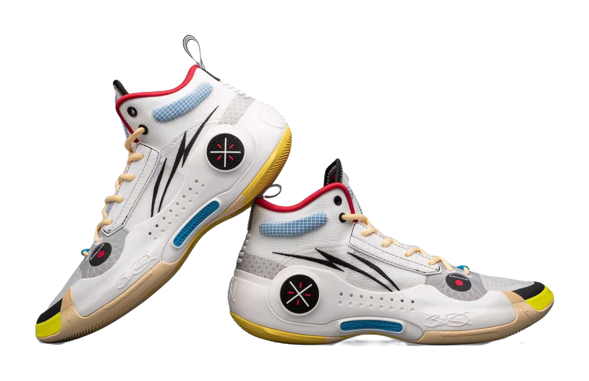 White mid-top basketball sneakers side-by-side, black logo, red collar, blue accents, yellow sole