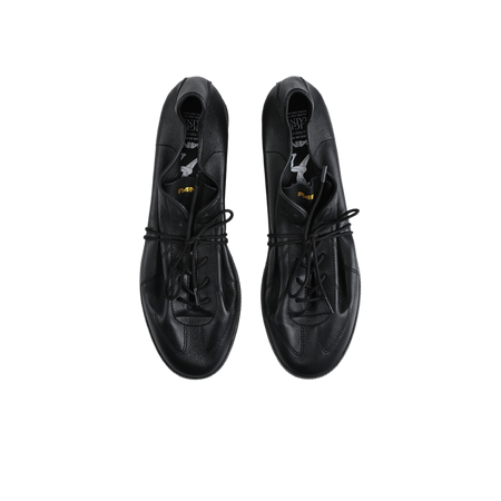 Pair of black lace-up low-top training sneakers with eyelets and perforated details.