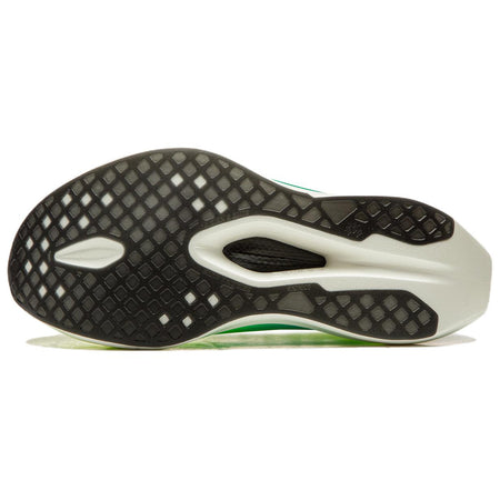 Racing shoe outsole with black traction pattern, white pods, green edge.