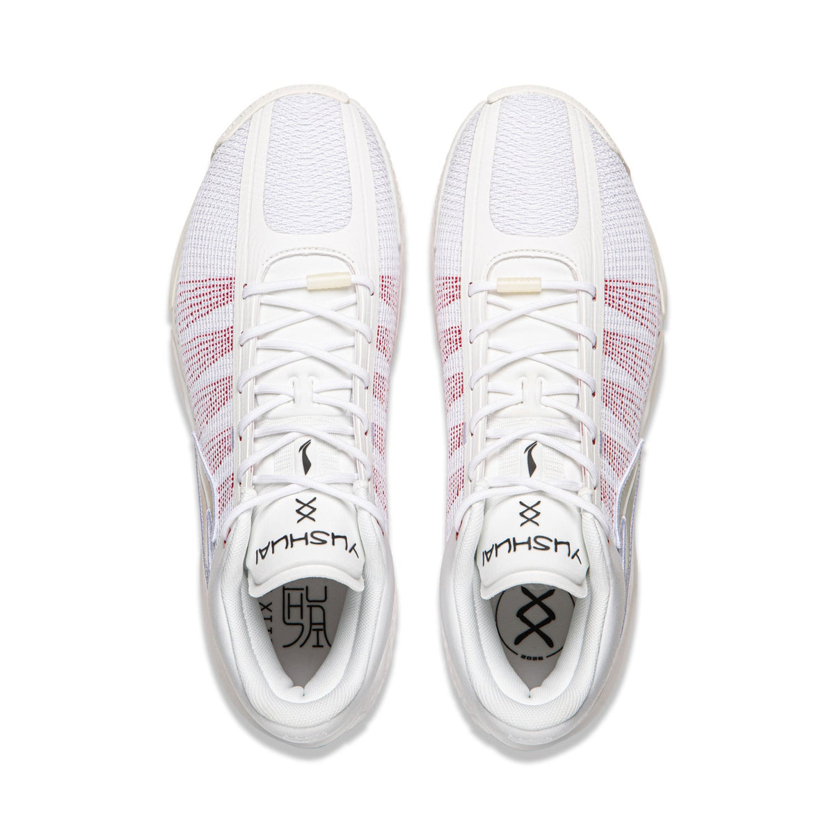 Pair of men's basketball shoes, white with red grid detailing, lace-up top view