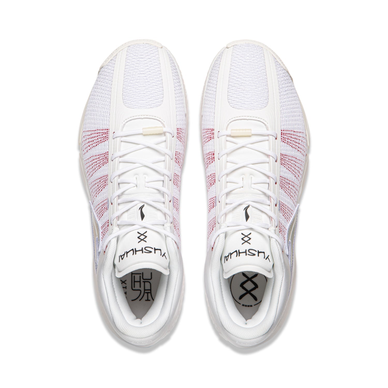 Pair of men's basketball shoes, white with red grid detailing, lace-up top view
