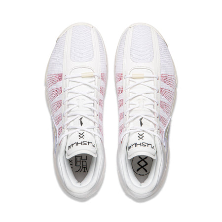 Pair of men's basketball shoes, white with red grid detailing, lace-up top view
