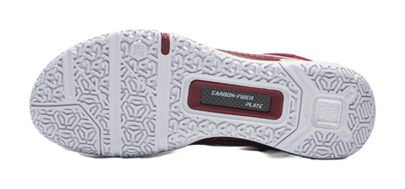White outsole of red badminton shoe with hex tread pattern and CARBON-FIBER plate.