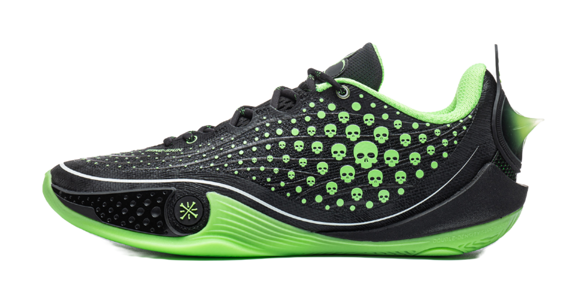 Low basketball shoe in black with neon green skull dot print and stripe sole