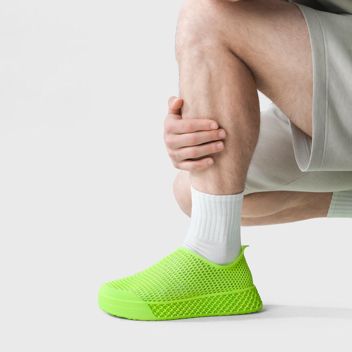 3D printed casual sneakers in lime green, perforated slip-on upper on foot