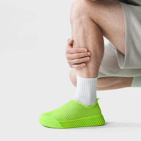 3D printed casual sneakers in lime green, perforated slip-on upper on foot
