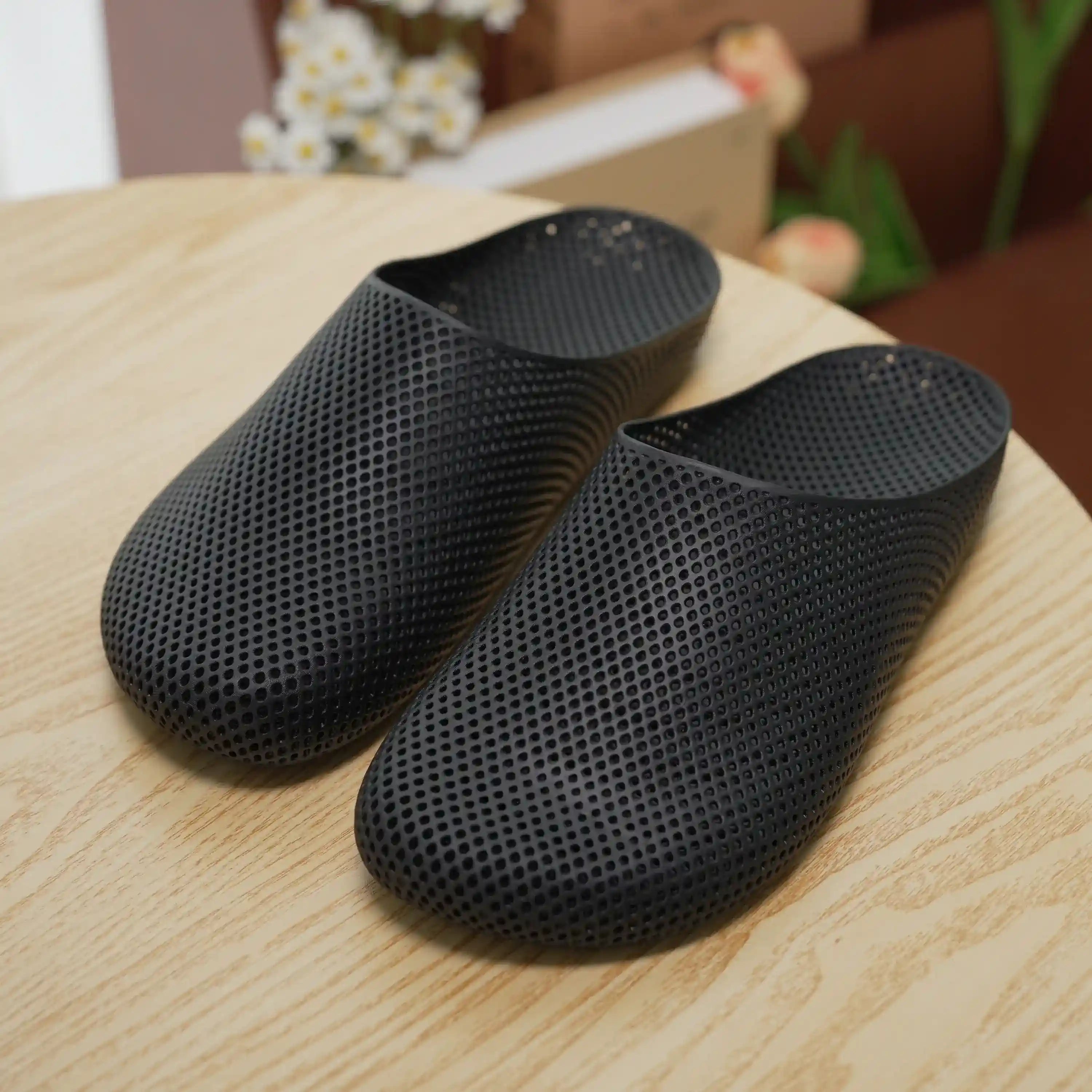 Black 3D printed slip-on slippers with textured mesh and cushioned sole