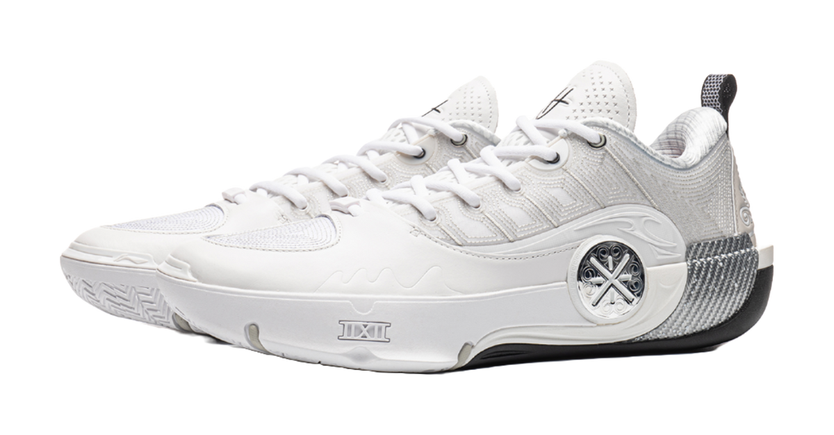 White basketball shoe with lace-up front, padded tongue, and round logo badge