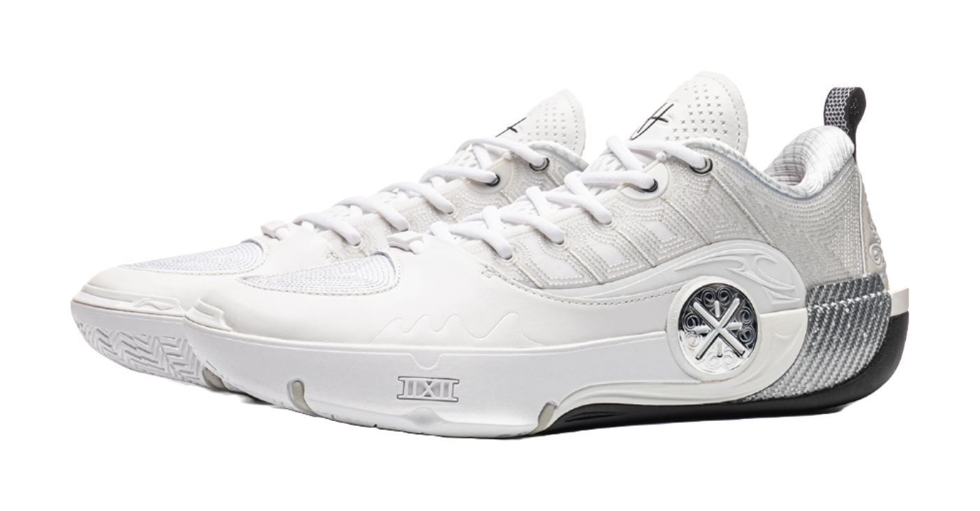 White basketball shoe with lace-up front, padded tongue, and round logo badge