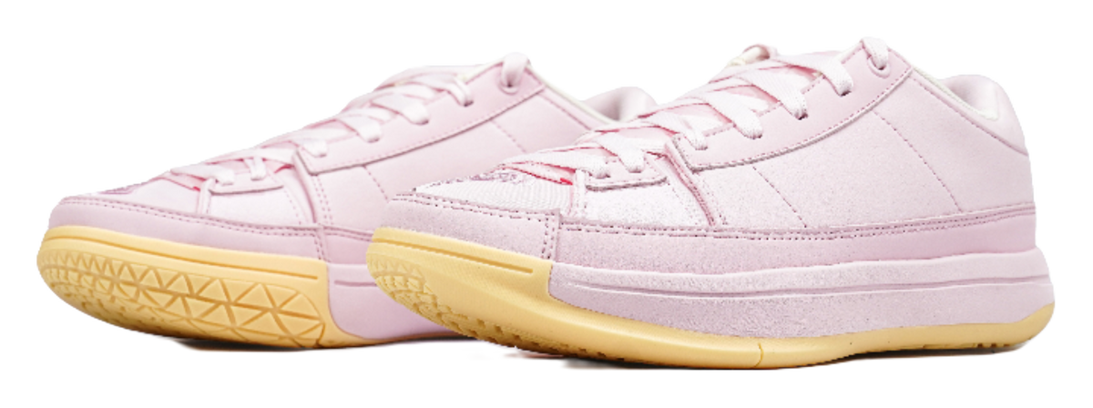 Pink low-top basketball shoes, side view, with white laces and white-pink panels