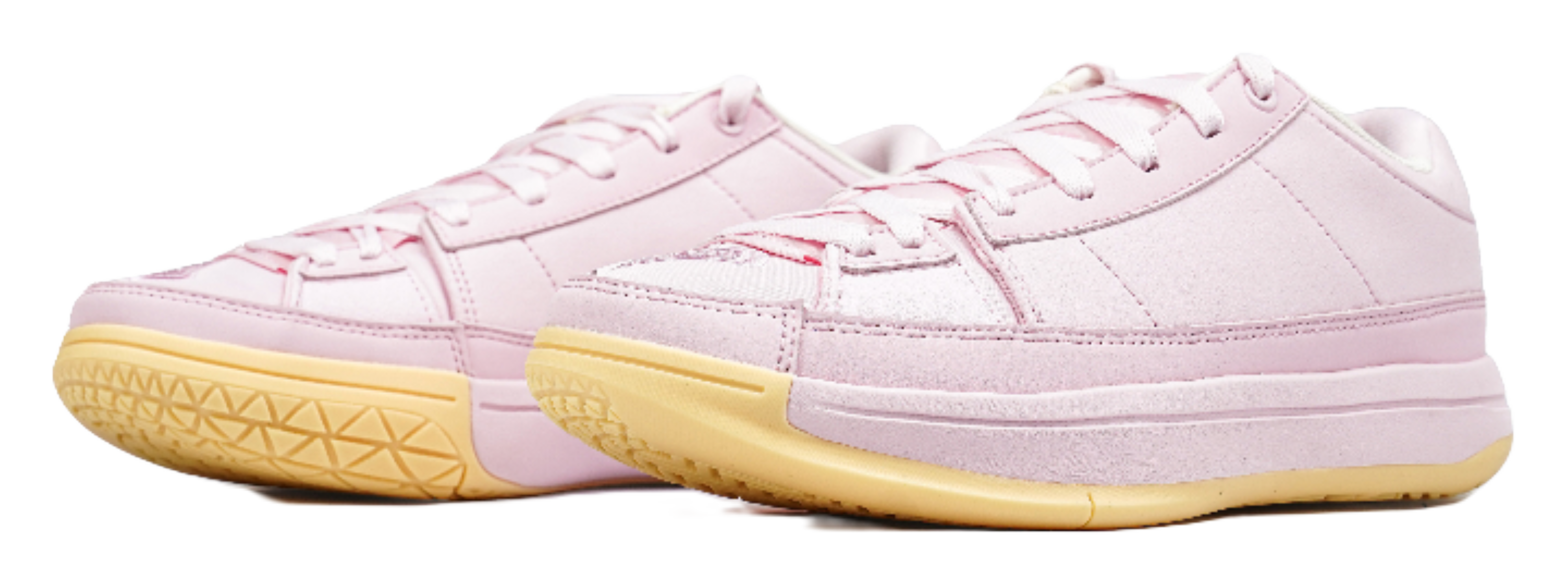 Pink low-top basketball shoes, side view, with white laces and white-pink panels