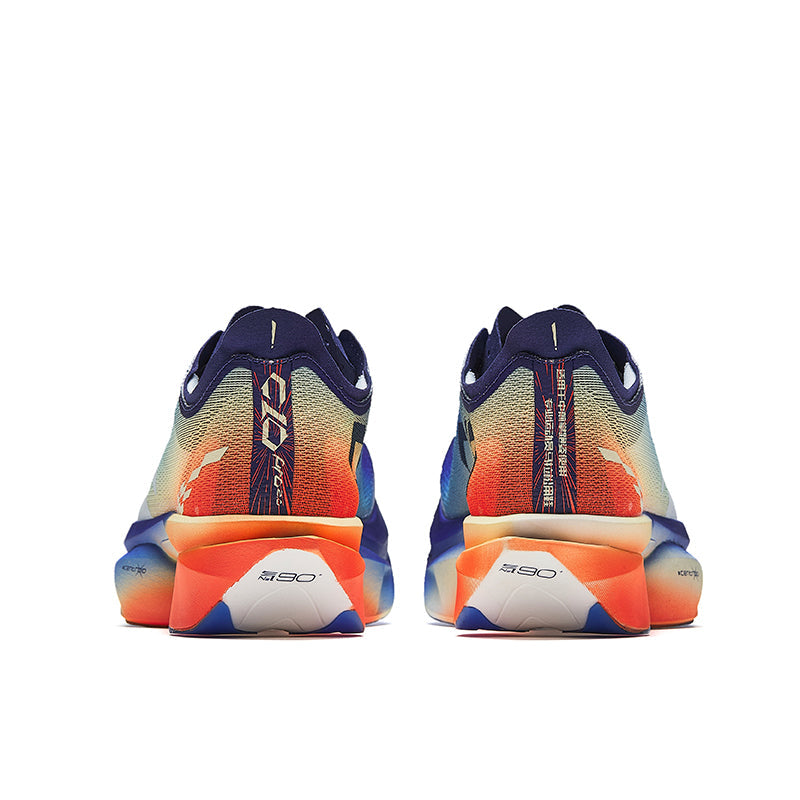Running shoes heel view with orange outsole pods, blue knit panels, and navy heel