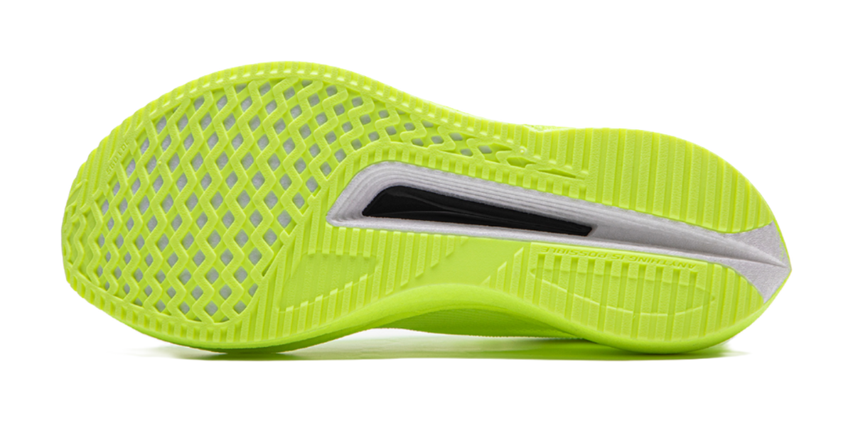 Neon yellow green running shoes, outsole side view, textured traction pattern