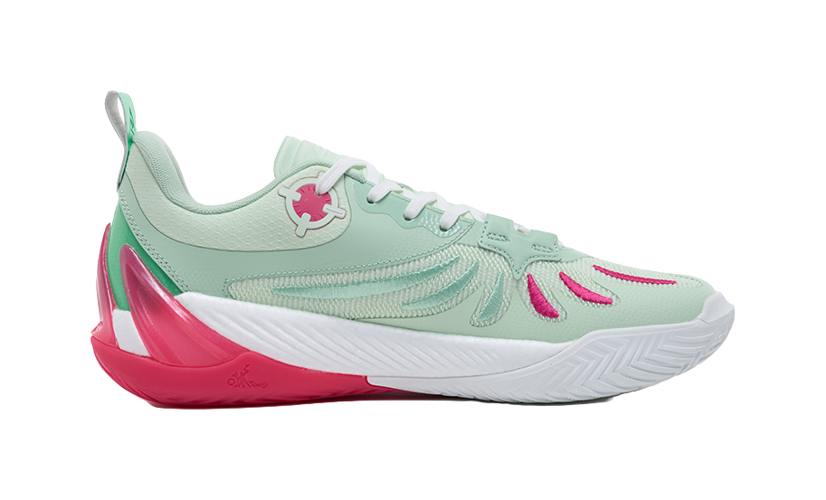 Mint green basketball shoe with pink detailing on the side and white tread sole