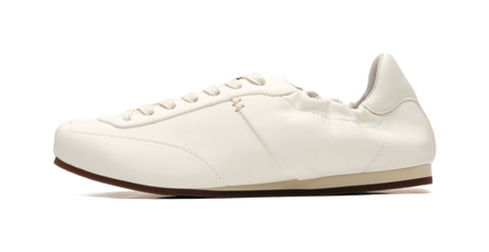 Antique white low-top trainers side view, lace-up eyelets and thin dark sole edge