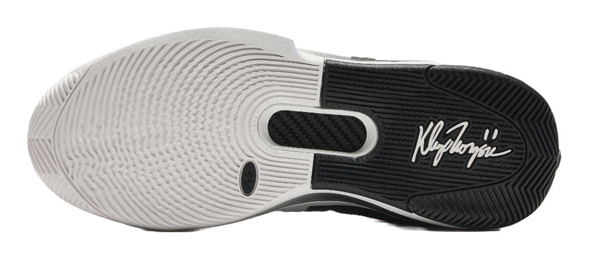White basketball shoe outsole with tread pattern and signature-style logo