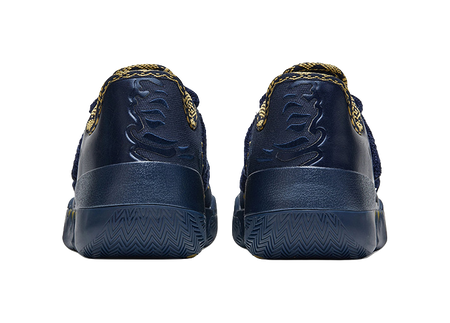Back view of blue low-top basketball shoes with textured heel panels and gold details