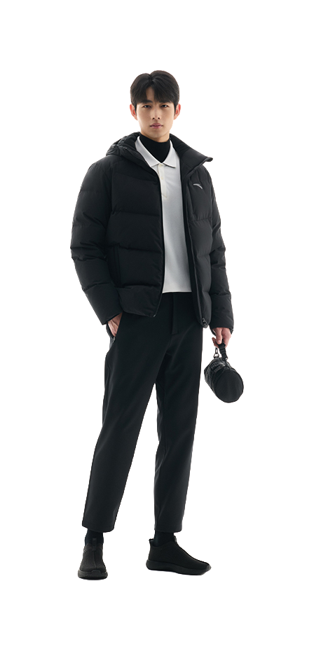Men's black hooded puffer down jacket worn with dark pants and tee