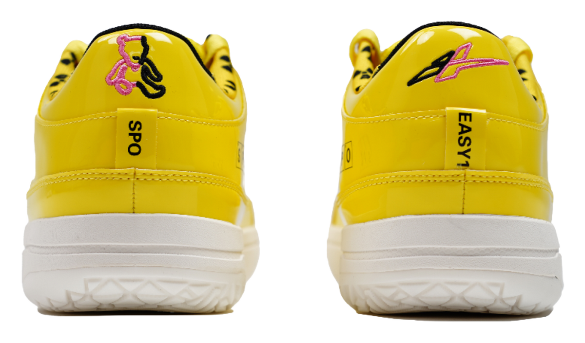 Yellow basketball shoes with heel pull tabs and white outsoles