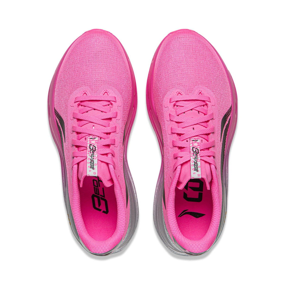 Pair of women's pink running shoes, lace-up tongues shown, gray interior accents