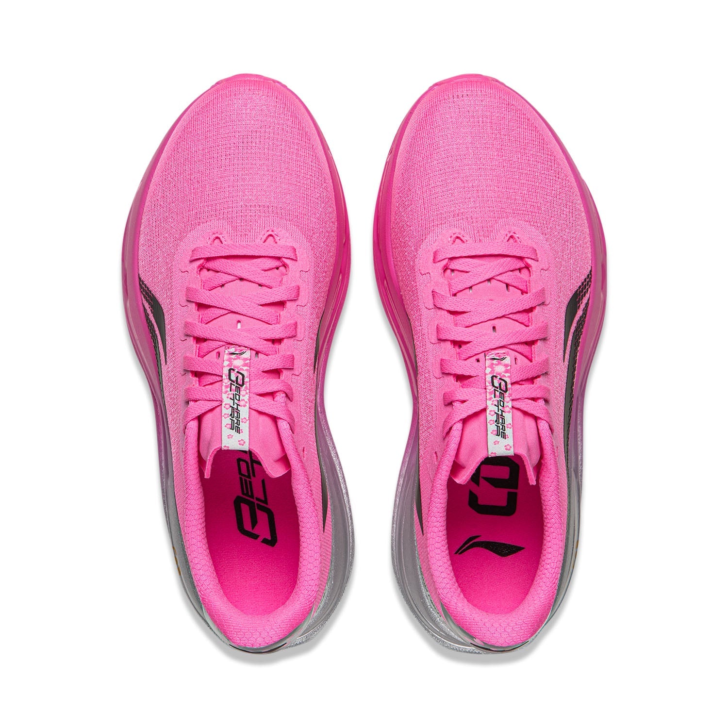 Pair of women's pink running shoes, lace-up tongues shown, gray interior accents