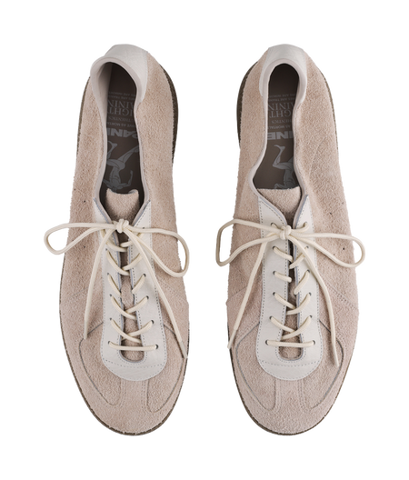 Khaki suede sneakers with laces, showing interior lining and open collar