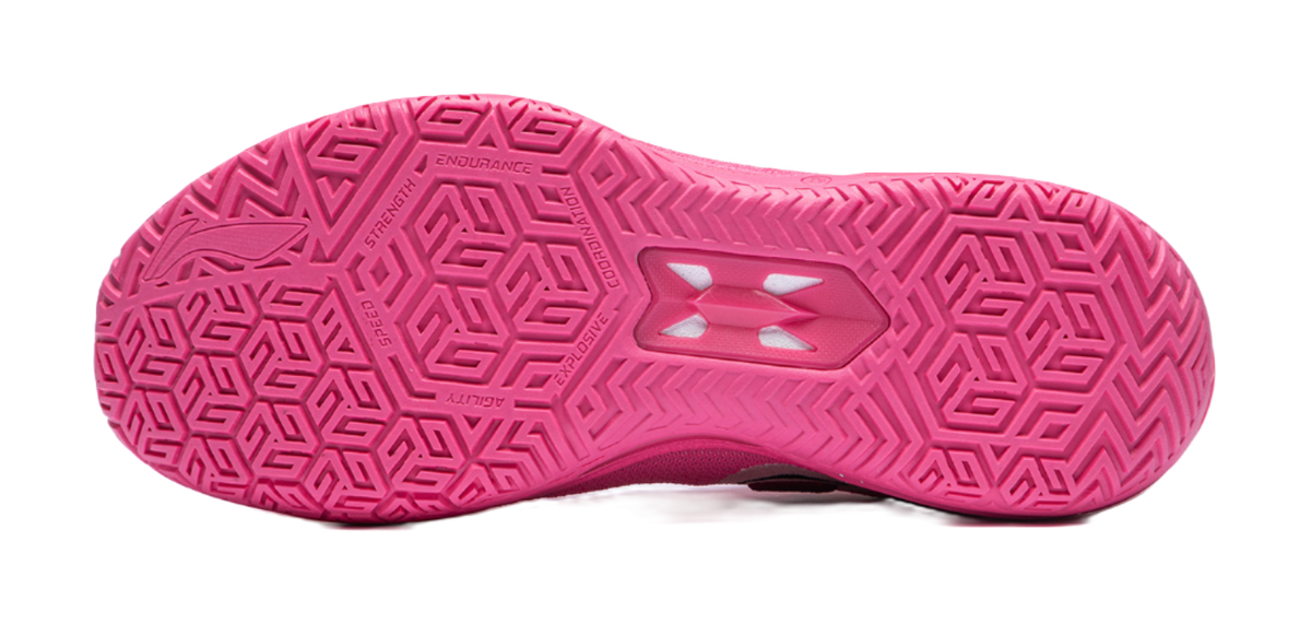 Pink basketball shoe outsole with geometric traction pattern and central support plate.