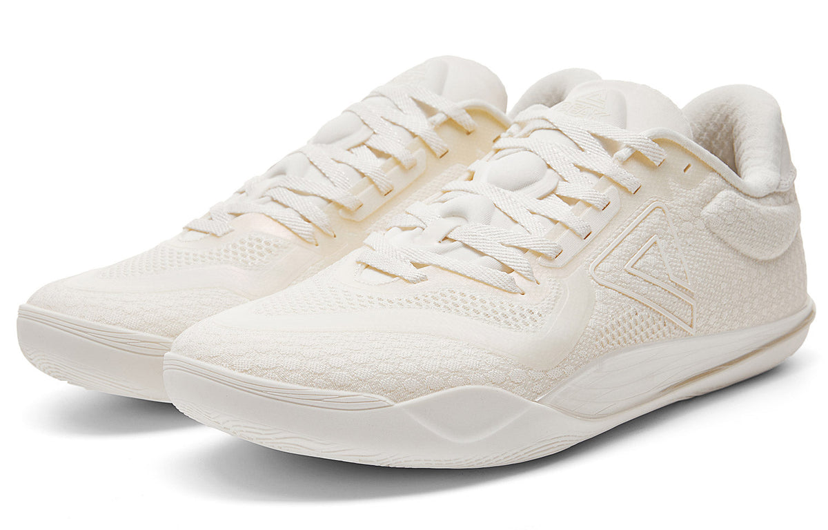 Milky white low-top basketball shoe angled front view with lace-up and logo panel