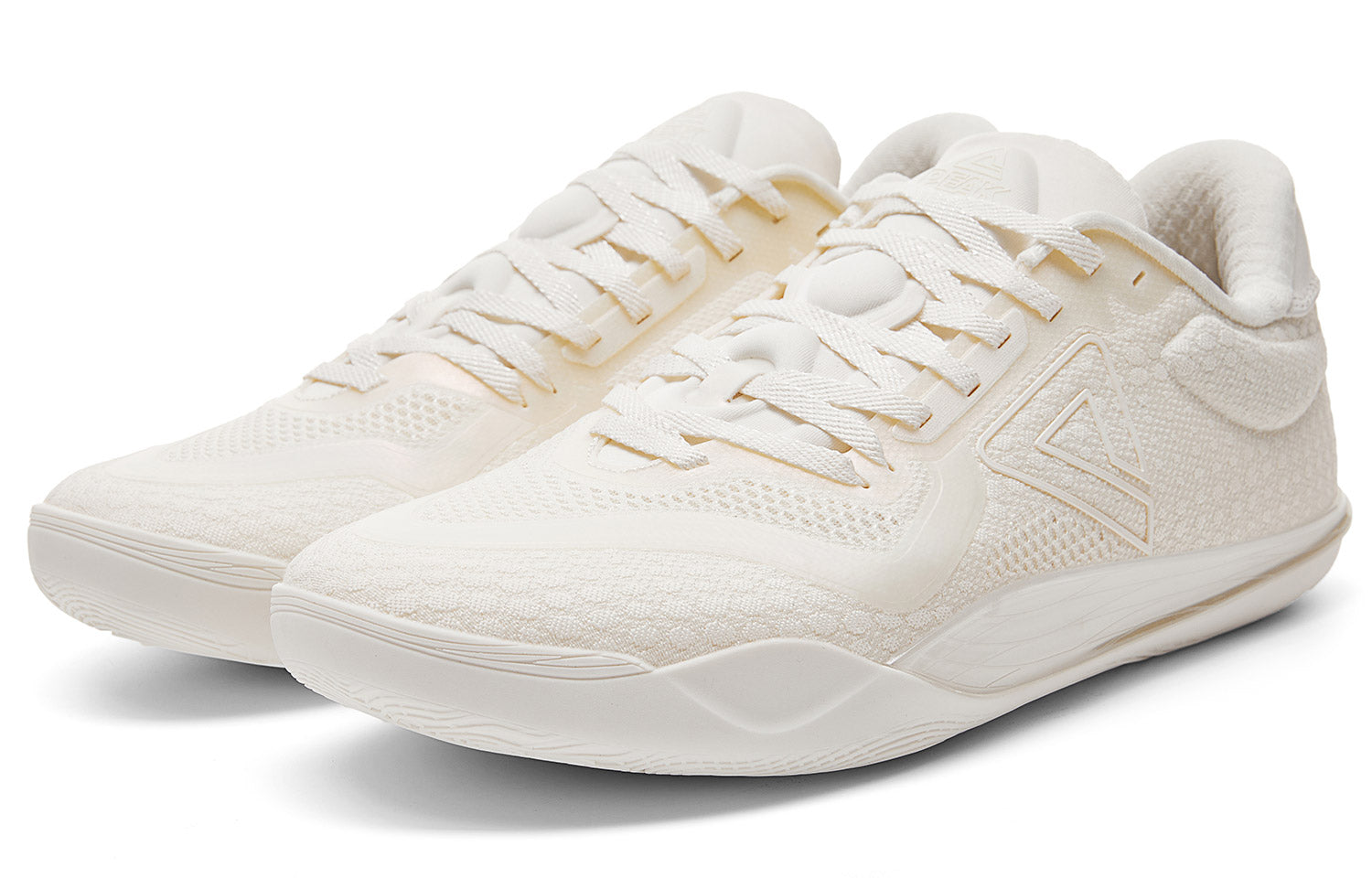 Milky white low-top basketball shoe angled front view with lace-up and logo panel
