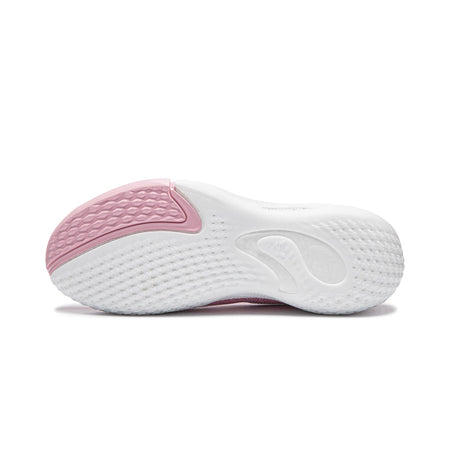 Pink and white basketball shoe outsole with textured rubber tread
