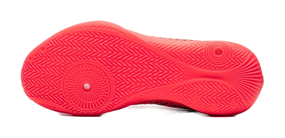 Fluorescent red basketball shoe outsole with textured tread and circular grip pattern