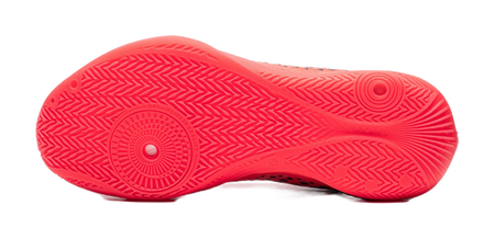 Fluorescent red basketball shoe outsole with textured tread and circular grip pattern