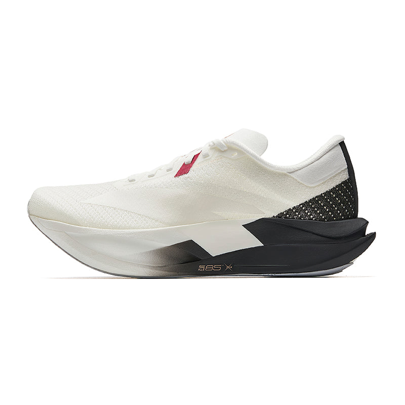 White running shoe with black heel panel, knit texture, red lace accent and foam sole
